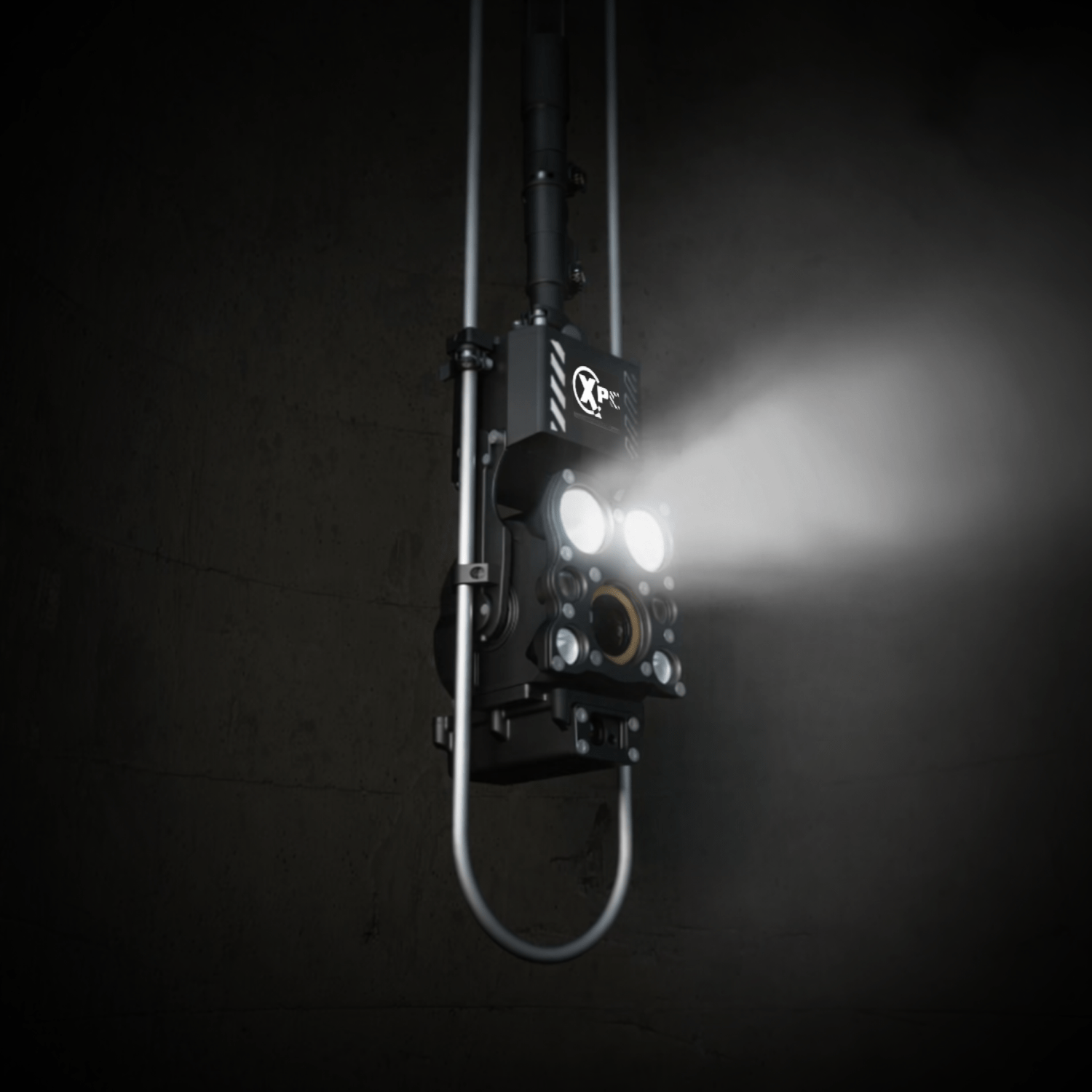 Scanprobe XPC pole camera lowered inside a manhole with its inspection lights illuminating the chamber.